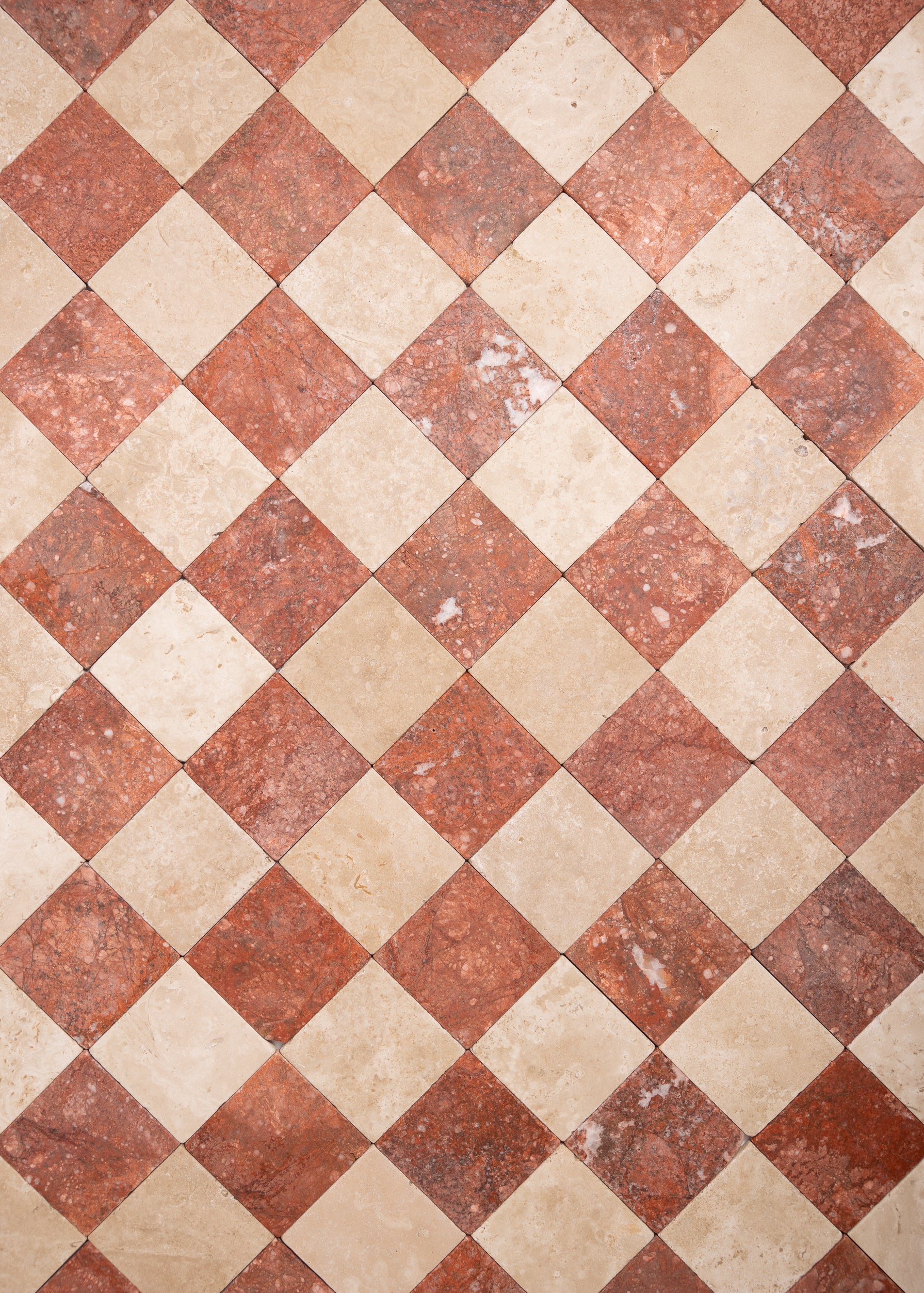 Beige and red tumbled marble checkered tile pattern in 4x4 squares