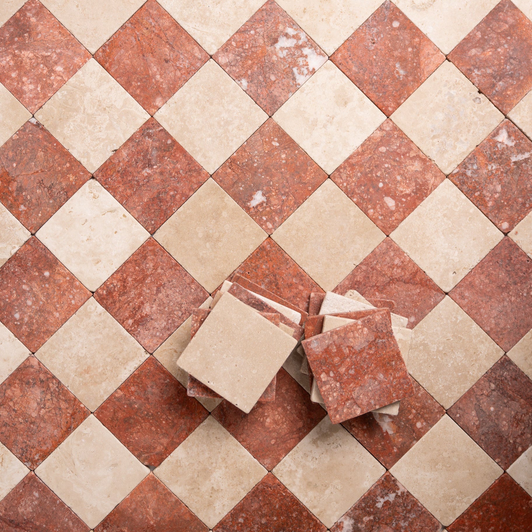 Beige and red tumbled marble checkered tile pattern in 4x4 squares