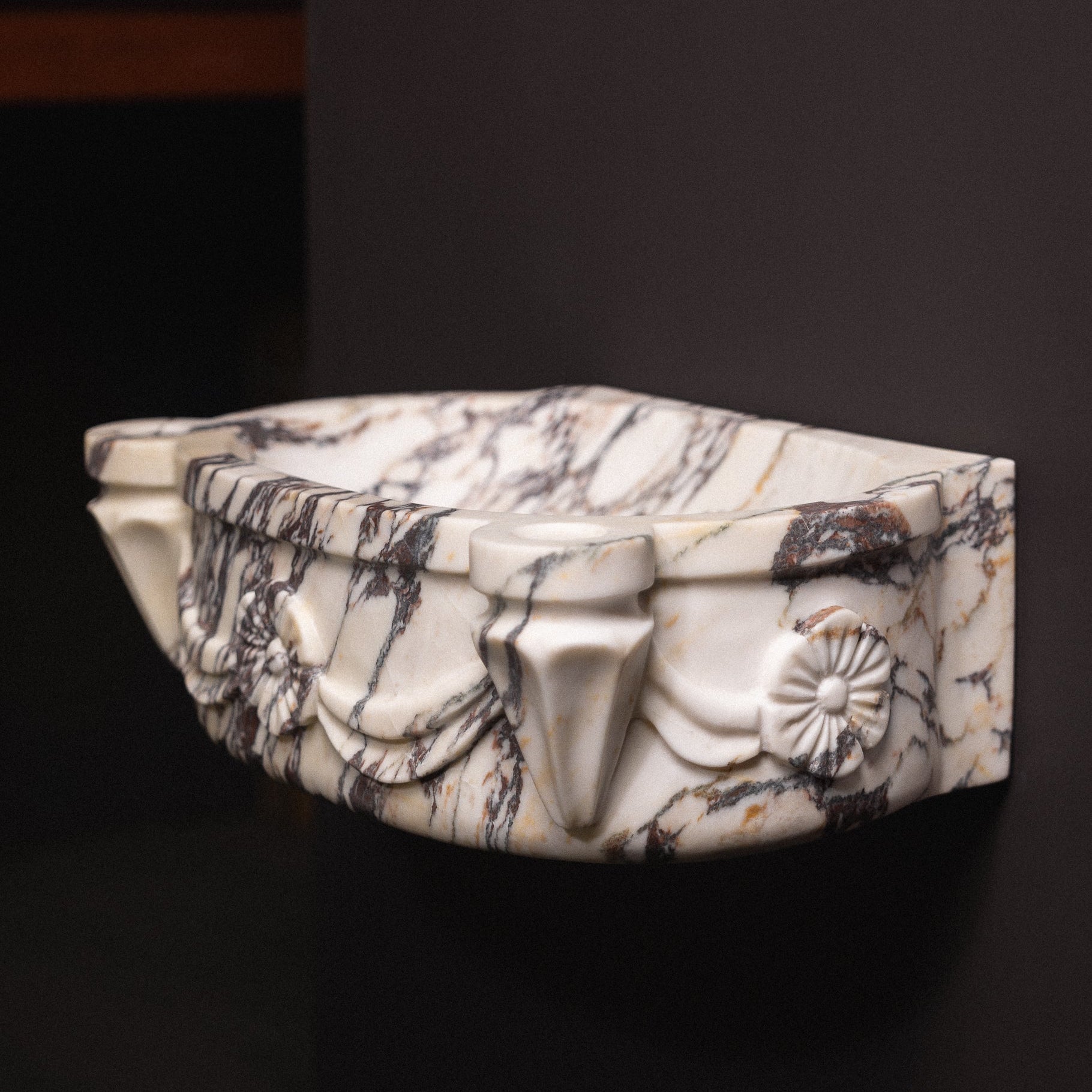 Calacatta viola marble floating wall-mounted sink with floral rosette carvings and draped detailing — luxury hand-carved marble basin for bathrooms.